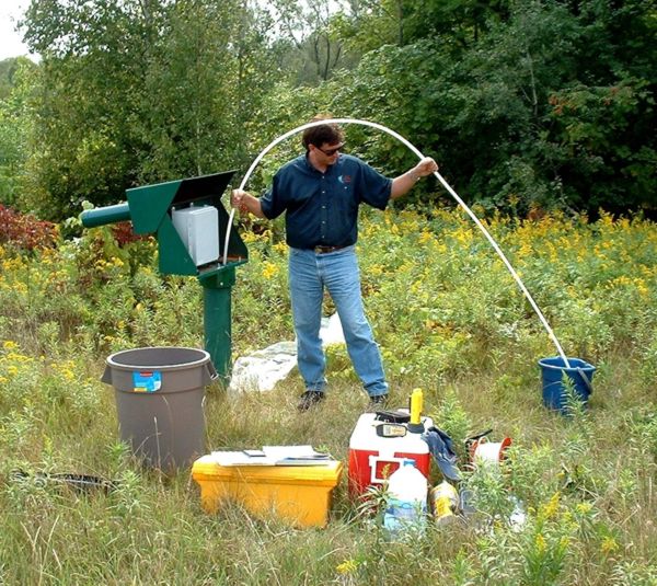 CLOCA staff taking groundwater sample.